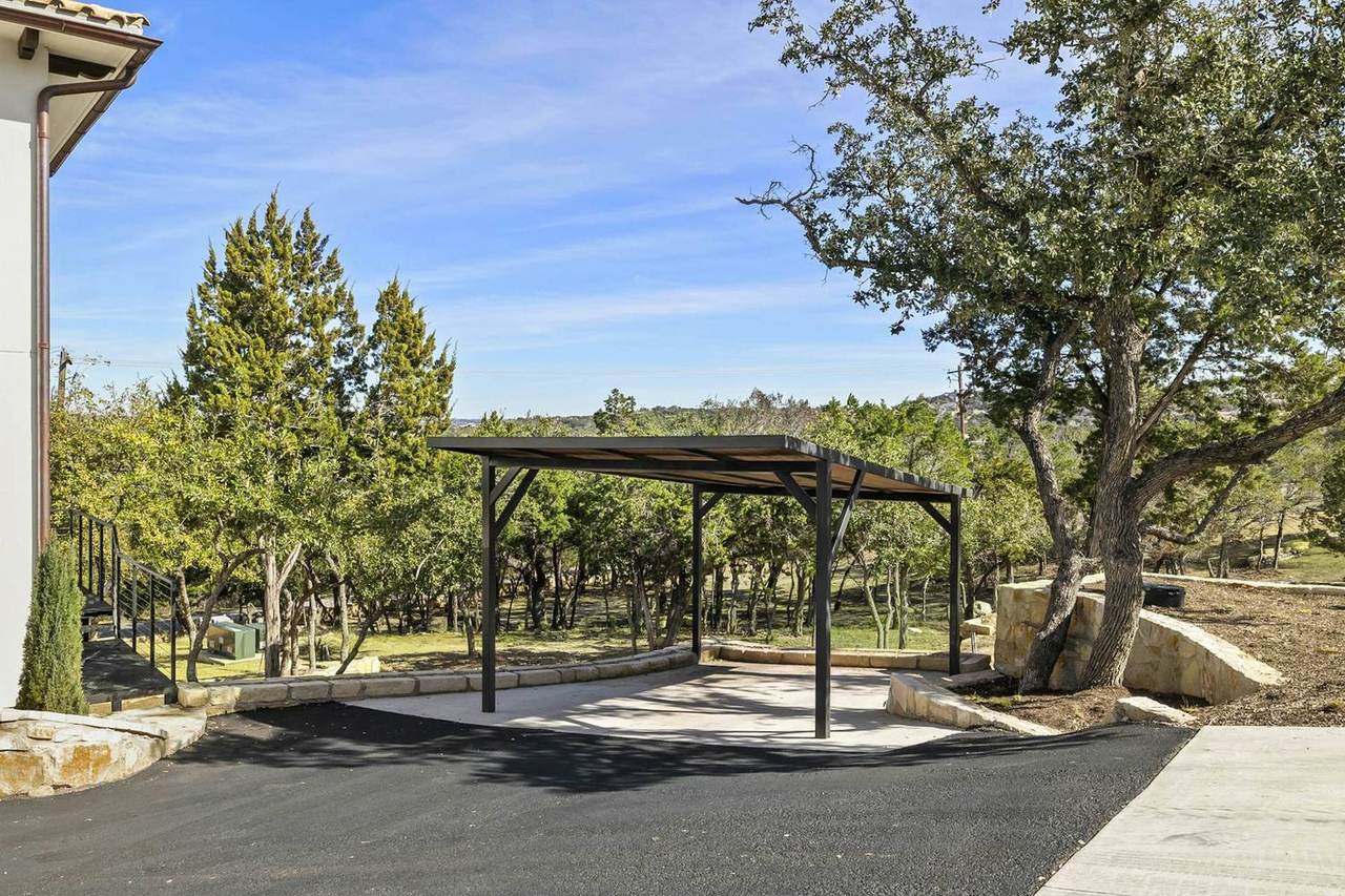 Villas set into the cedar-and-oak hillside at Las Luces Village