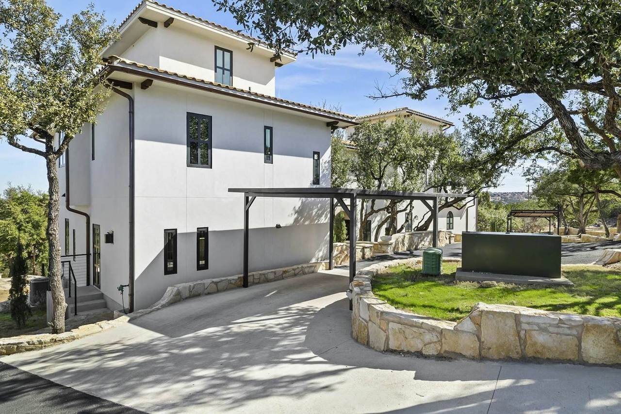 Two-story villa exterior under a clear sky at Las Luces Village