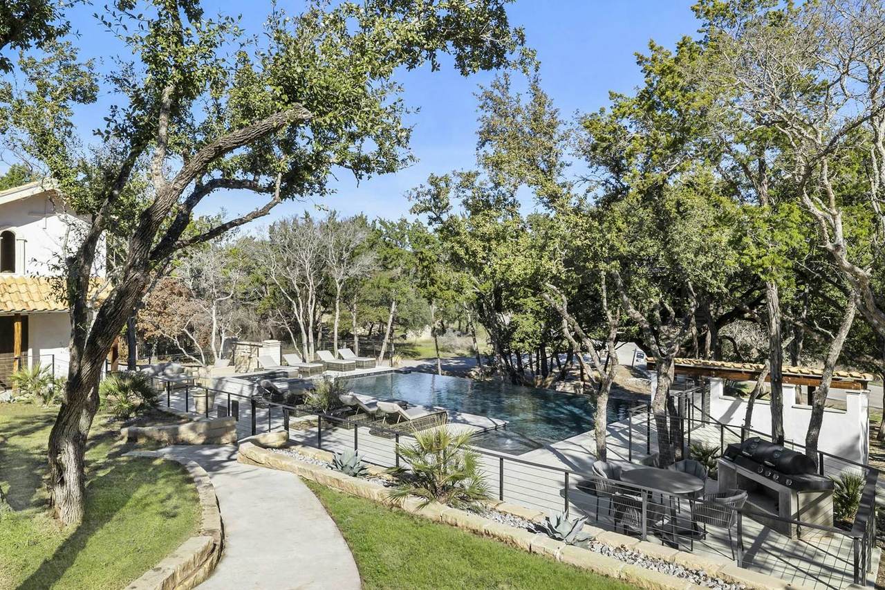 Pool area with garden path at Las Luces Village