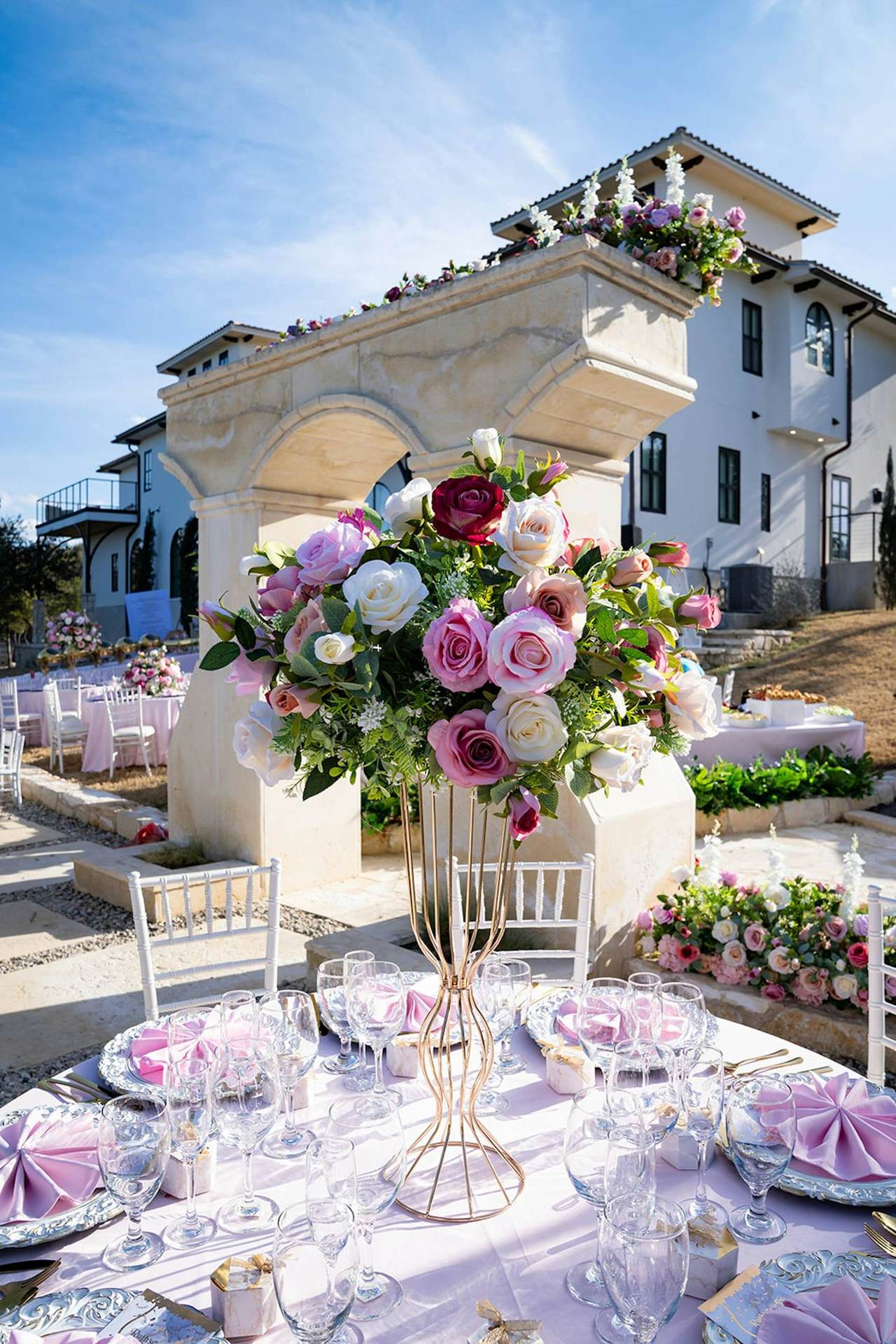 Wedding table with a pink and white floral centerpiece